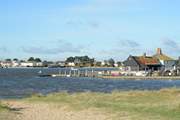 Looking across the mouth of Christchurch Harbour towards Mudeford Quay, ferry trips and adventure boat trips leave from the Quay.