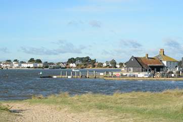 Looking across the mouth of Christchurch Harbour towards Mudeford Quay, ferry trips and adventure boat trips leave from the Quay.