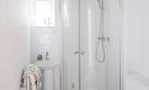 The en suite to the main bedroom is very compact with a drench head shower and petite hand basin. - Thumbnail Image