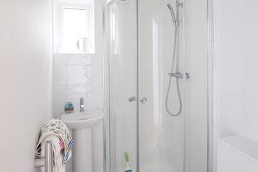The en suite to the main bedroom is very compact with a drench head shower and petite hand basin.