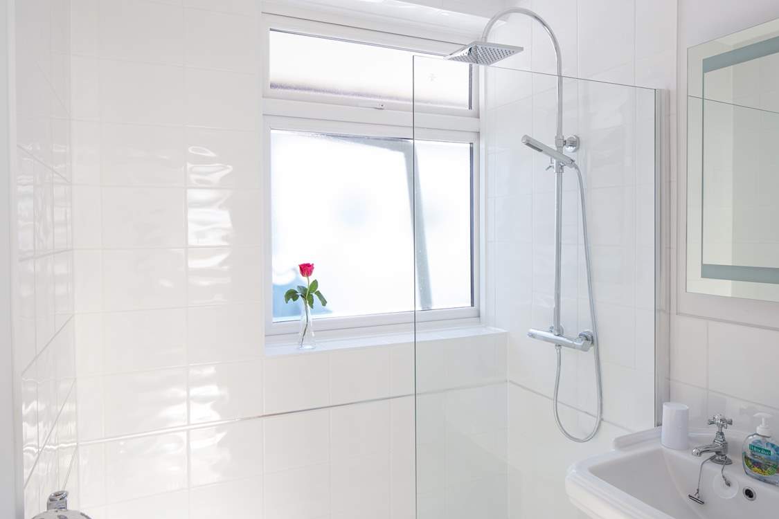 The family bathroom has a large shower with drench head.