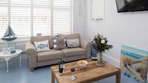The open plan living-room is filled with light and has stylish plantation shutters. There is a Sonos Bluetooth system, so you can have music to relax to or simply watch the Smart TV. 