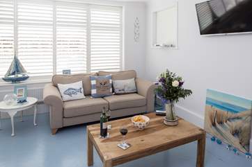 The open plan living-room is filled with light and has stylish plantation shutters. There is a Sonos Bluetooth system, so you can have music to relax to or watch the Smart TV which is Netflix enabled.