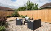 The back garden is fully enclosed with comfy garden seating in addition to a table and chairs. - Thumbnail Image