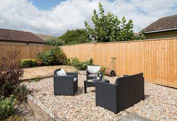The back garden is fully enclosed with comfy garden seating in addition to a table and chairs.