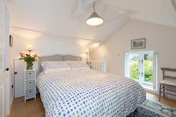 The bedroom with its striking French country style bed is on the first floor.