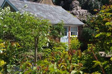 The cottage is surrounded by beautiful shrubs and plants, giving a good sense of privacy.