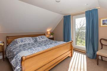 This is the master bedroom on the first floor, with its Juliette balcony and king-size bed.