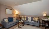 The cosy first floor sitting-room has two comfortable sofas and wonderful views. - Thumbnail Image