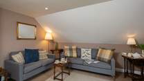 The cosy first floor sitting-room has two comfortable sofas and wonderful views.