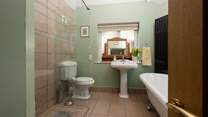 The ground floor bedroom has this en suite bathroom with separate shower cubicle.