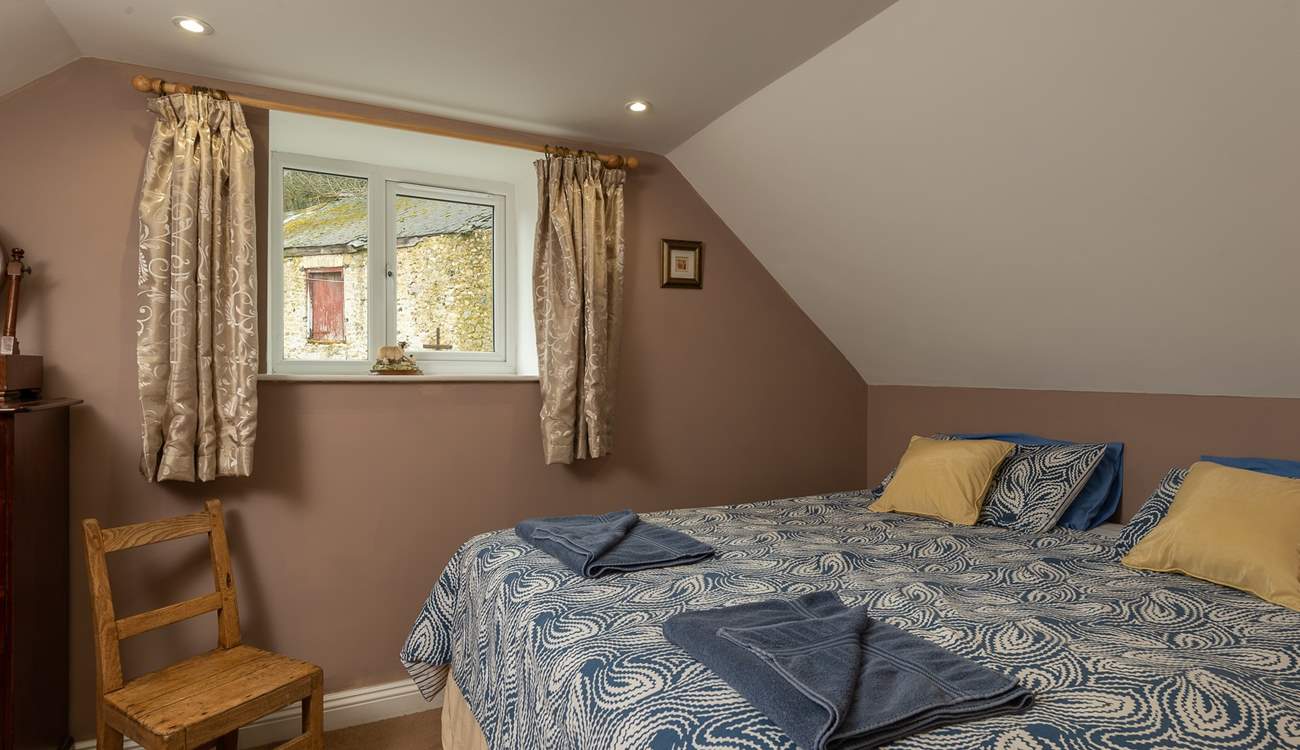 This is the master bedroom on the first floor. It looks out over some of the original farmstead buildings.