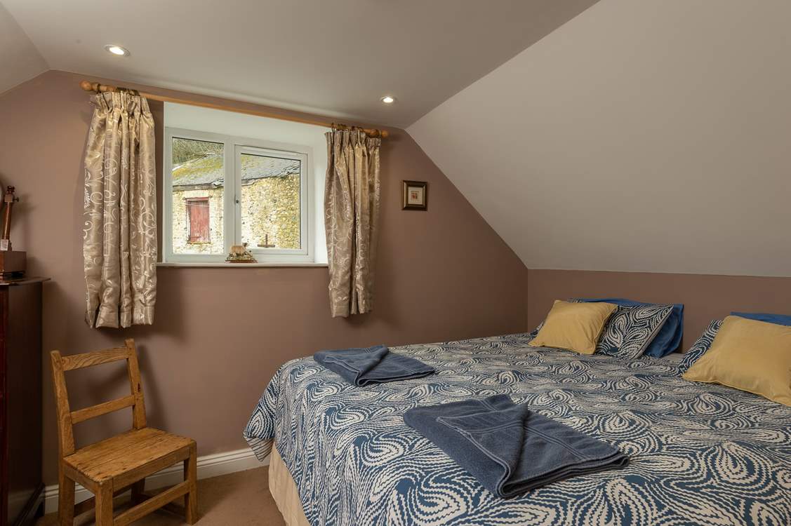 This is the master bedroom on the first floor. It looks out over some of the original farmstead buildings.