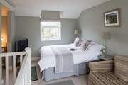 The calm and comfortable open plan sitting/bedroom