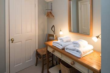 There is a small dressing area in front of the shower-room.