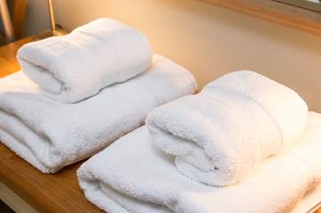 White fluffy towels are provided.