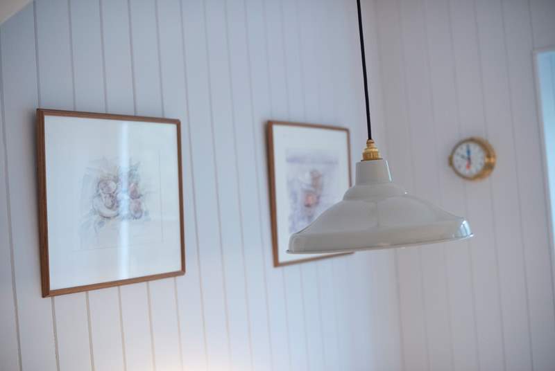 A retro light hangs low over the dining table.