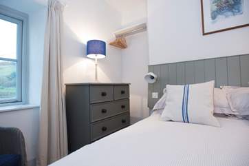 Furniture is painted in complementary shades of blue and grey.