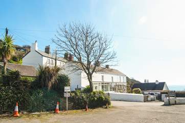 This is the village car park where you can park and 9 Coastguard Terrace is the top left hand cottage in the picture.
