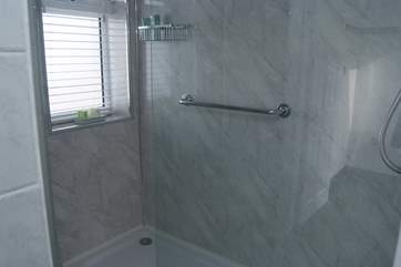 The gorgeous modern shower-room has a huge shower.