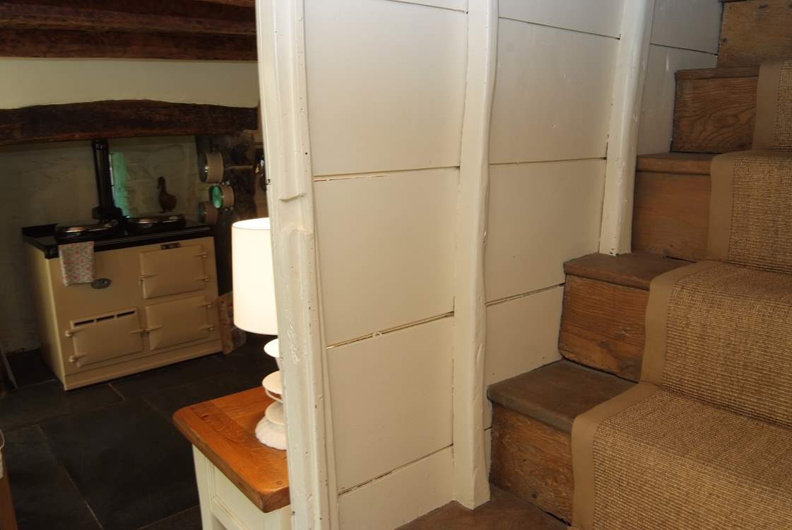 The cottage stairs lead to the bedrooms and bathroom.