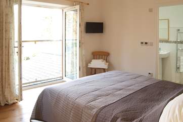The master bedroom has French doors and a Juliet balcony to make the most of the views.