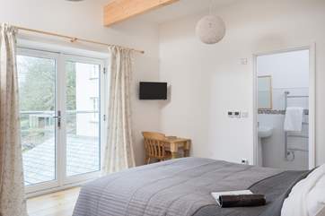 The double bedroom has a Juliet balcony with views down to the valley below.