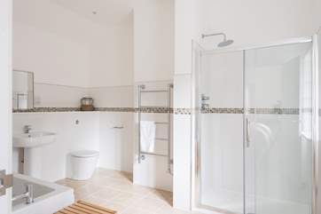 This huge bathroom includes a large shower cubicle...