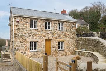 Tin Stream cottage sits alongside the Owners home behind and Shuffley Barn behind that.