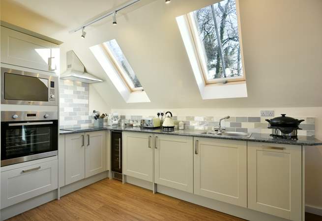 There is a super-contemporary kitchen fitted around this corner of the living space.