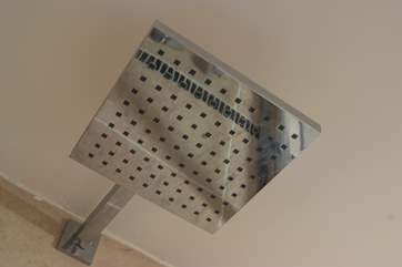 A big shower head for a drenching shower.
