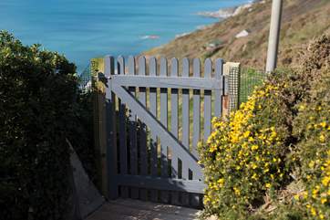 The gate to the pathway which leads up to the road or down to the beach.