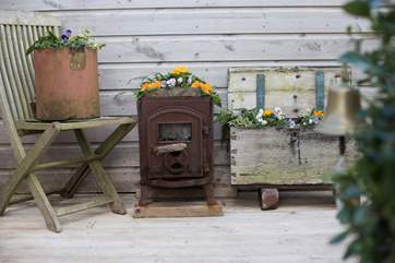 Pretty plants in a variety of unusual containers all add to the charm.