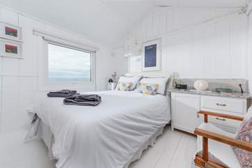 The master bedroom with its comfy king-size bed and a view straight out to sea.