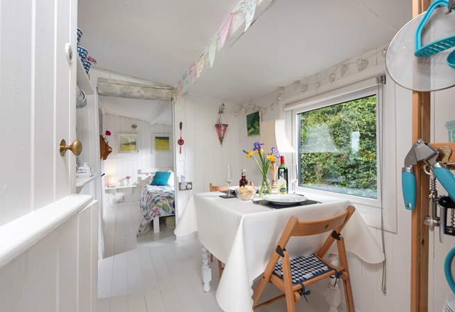 The pretty dining-area, with bunting and fairy lights adding to the charm.