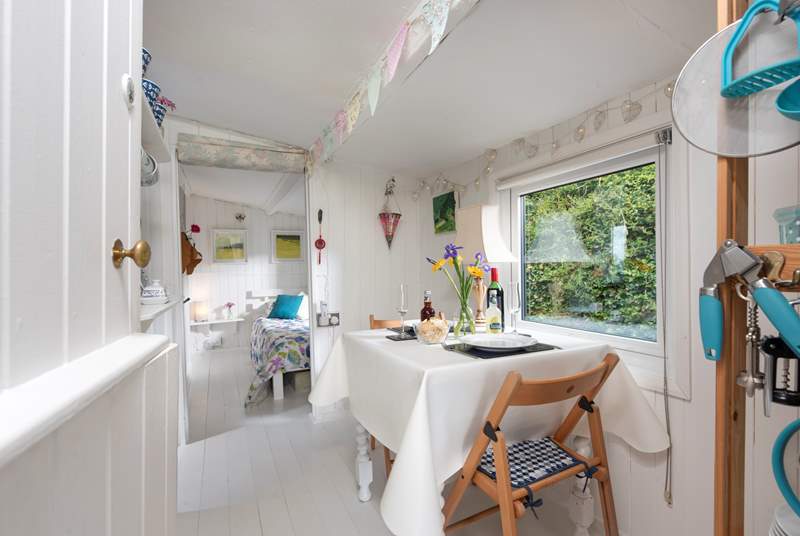 The pretty dining-area, with bunting and fairy lights adding to the charm.