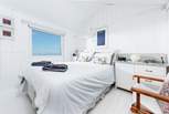 The main bedroom with its comfy bed and a view straight out to sea.
