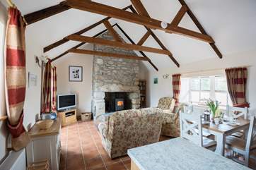 There are comfy chairs and a sofa around the fire, time to relax after a day out exploring.