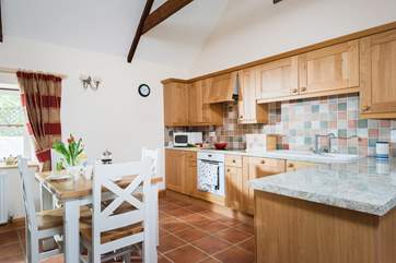 The well-equipped kitchen is on one side of the open plan living-room.
