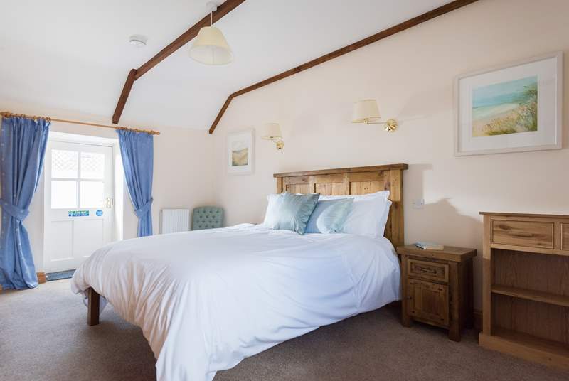 The solid wood five foot double bed in a spacious bedroom with lots of storage and an en suite bathroom.