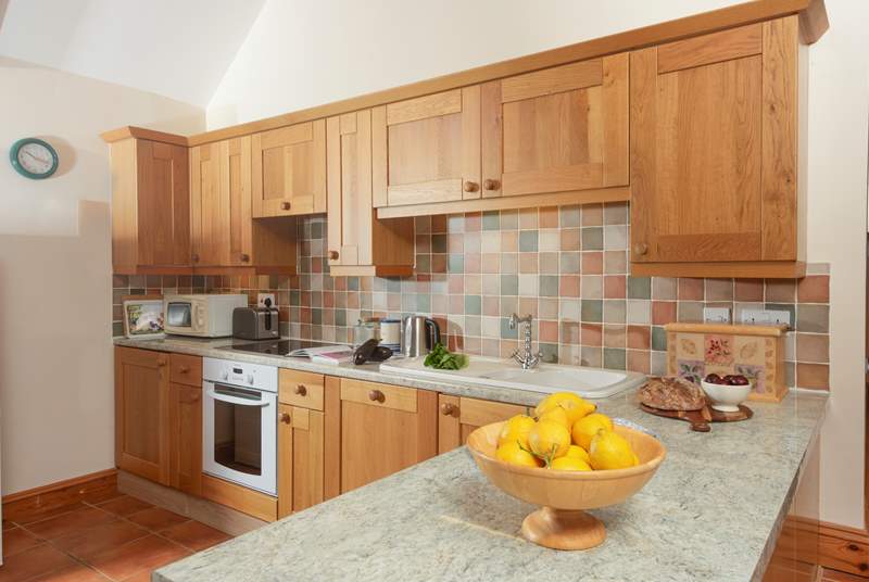 The well-equipped kitchen is on one side of the open plan living-room.