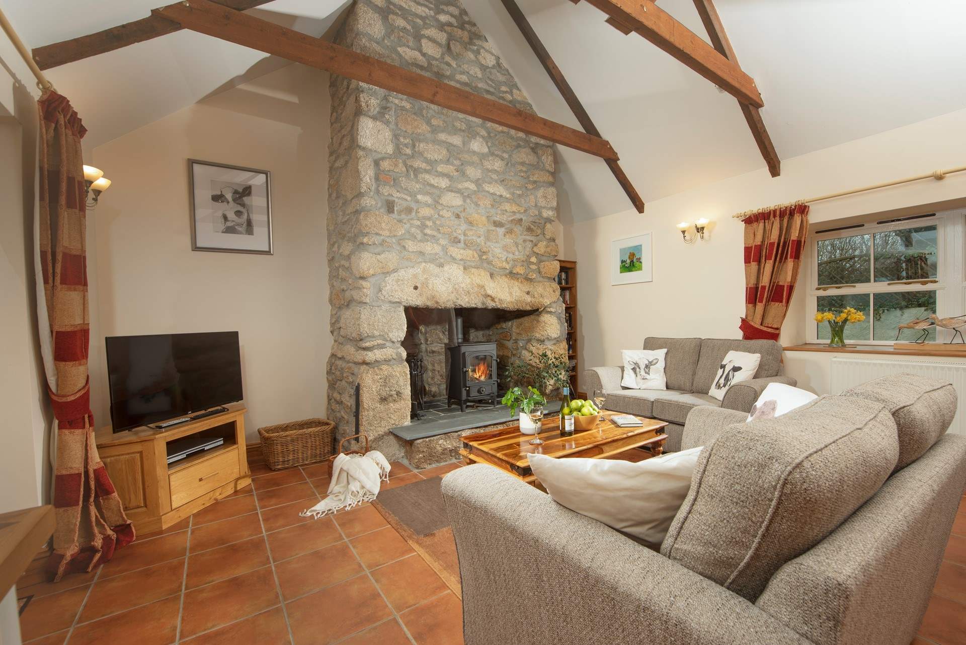 There are comfy chairs and a sofa around the fire, time to relax after a day out exploring.