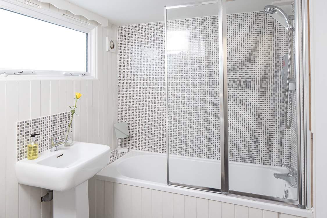 The ground floor bathroom has a large heated towel rail for toasty warm bathing.