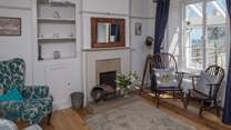 The sitting-room has both modern comfy chairs and those from its original working days.