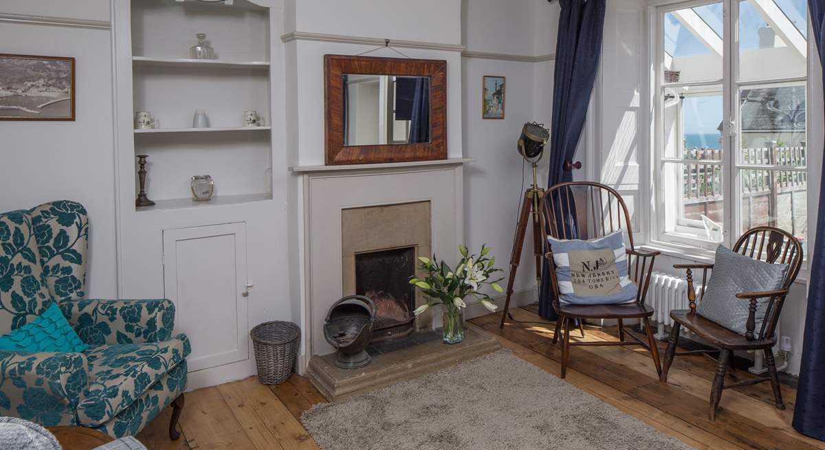 The sitting-room has both modern comfy chairs and those from its original working days.