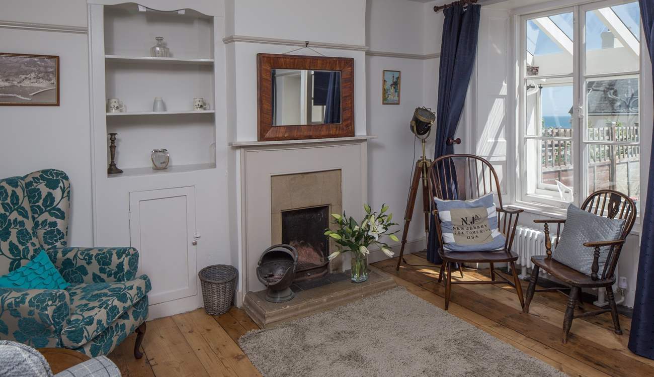 The sitting-room has both modern comfy chairs and those from its original working days.