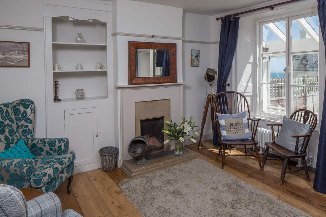 The sitting-room has both modern comfy chairs and those from its original working days.