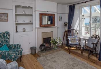 The sitting-room has both modern comfy chairs and those from its original working days.