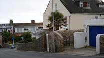 This is the view as you descend Cobb Road. The little gate is the access path to Cobb Cottage and the parking is just below. Turn right into the car park and the allocated space is at the end on the right.