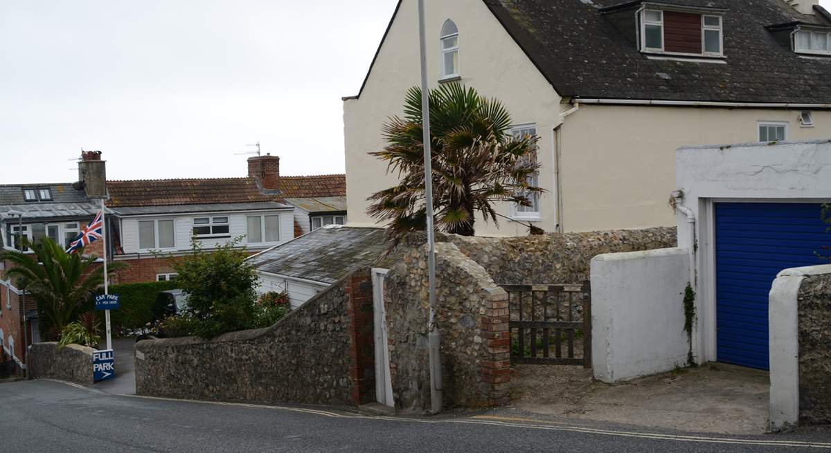 This is the view as you descend Cobb Road. The little gate is the access path to Cobb Cottage and the parking is just below. Turn right into the car park and the allocated space is at the end on the right.